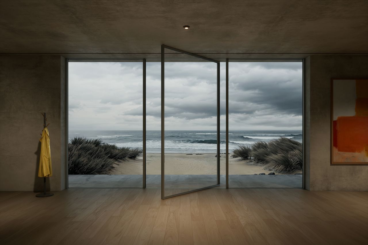 Rendered concrete room with a large Sky-Frame Pivot glass door turned open on its axis, facing a beach and sea